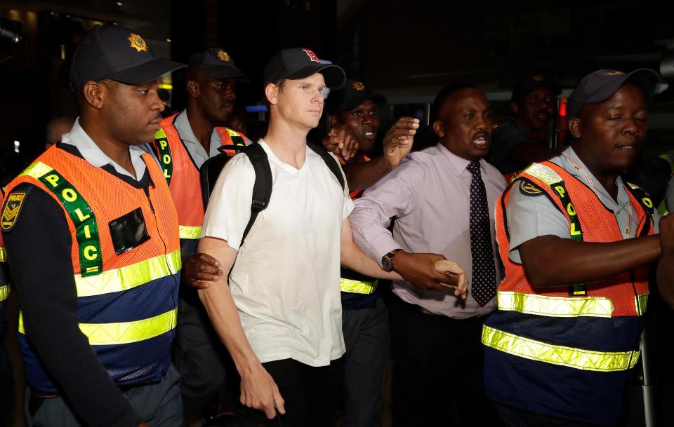  Disgraced cricketer Steve Smith is escorted by cops at OR Tambo Airport in Johannesburg