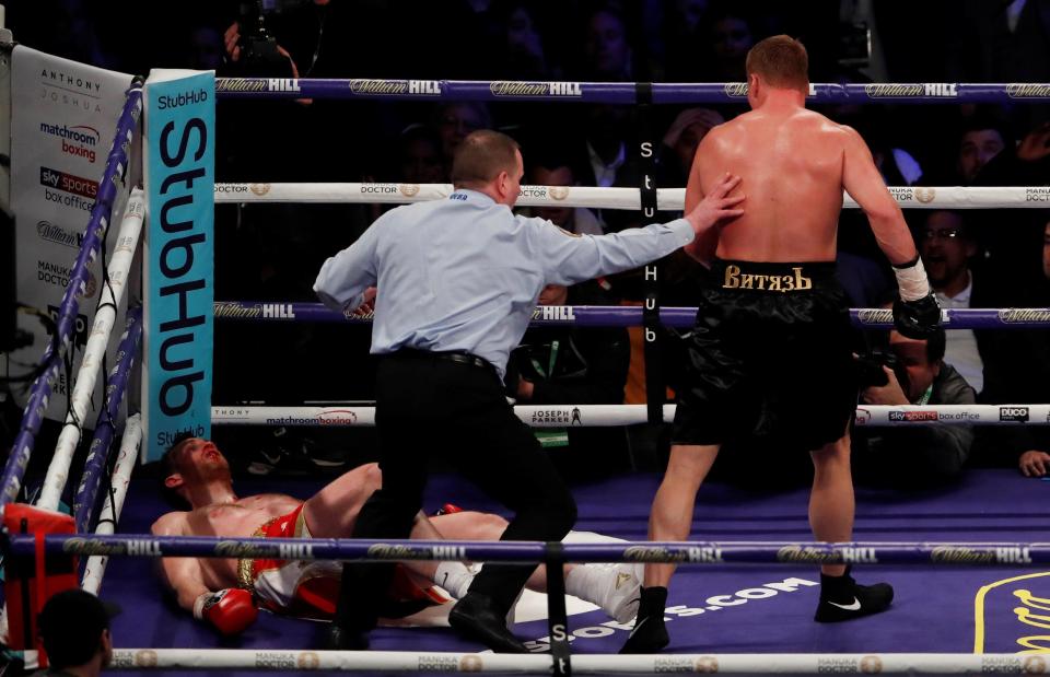  The Russian stands over the Brit heavyweight after putting him down in the fifth round