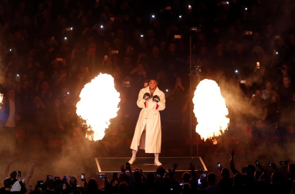  Anthony Joshua walks out at the Principality Stadium with fire shooting up around him