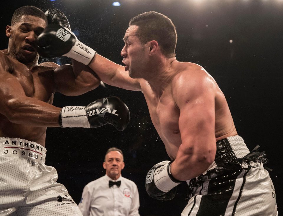  Anthony Joshua manages to block some of Joseph Parker's swing