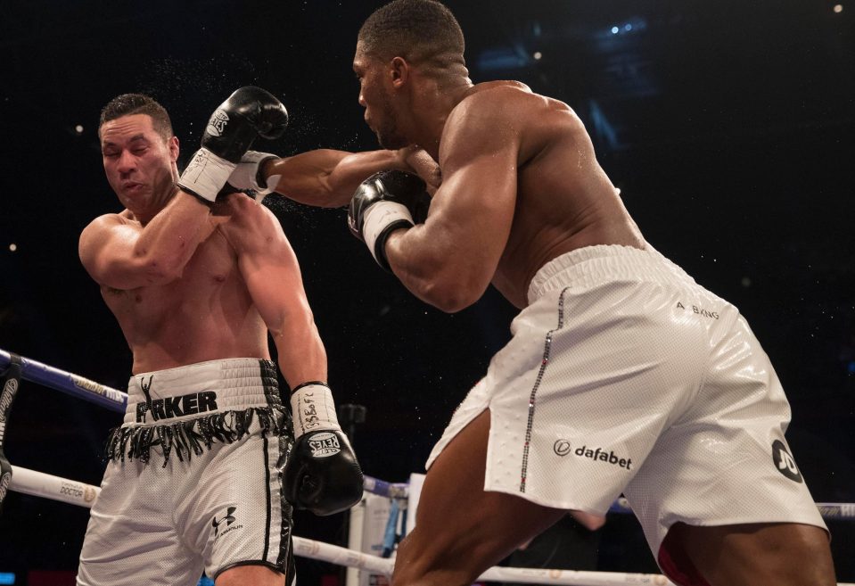  Joseph Parker recoils after being hit in the face by Anthony Joshua