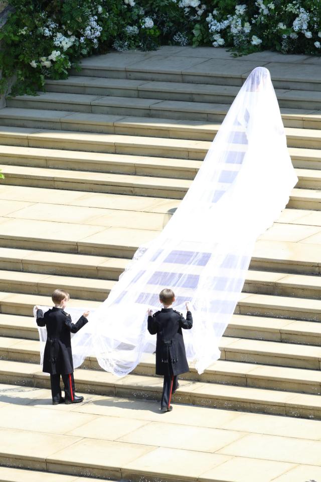  The pageboys hold up Meghan's veil as she walks into the chapel