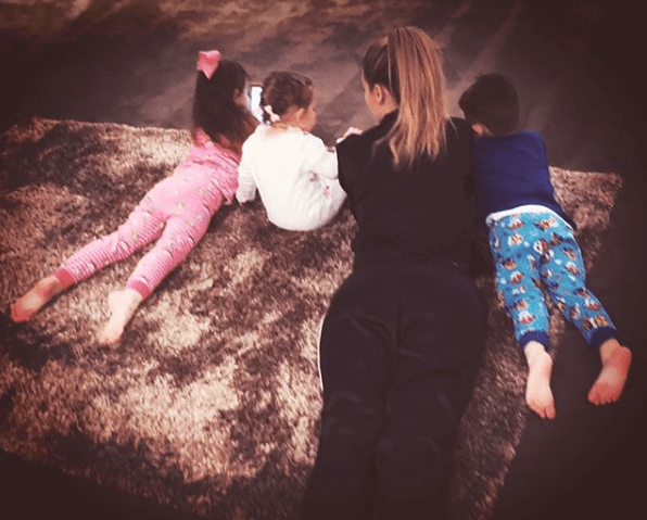  He posted this sweet snap of her relaxing with their children and described her as an 'amazing' mum