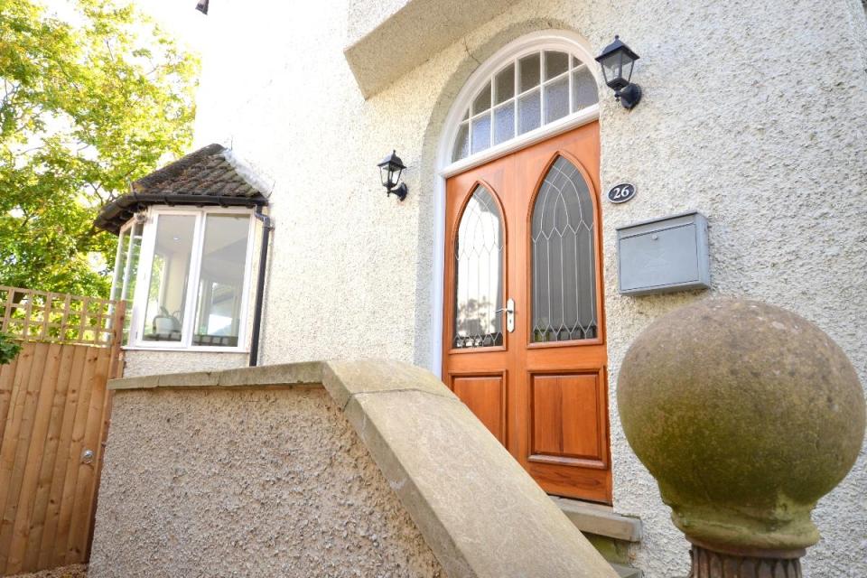  There's a Gothic style front door which opens into a porch area to the entrance hall