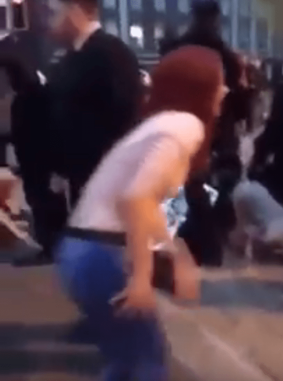  A woman limps past the camera in another piece of social media footage