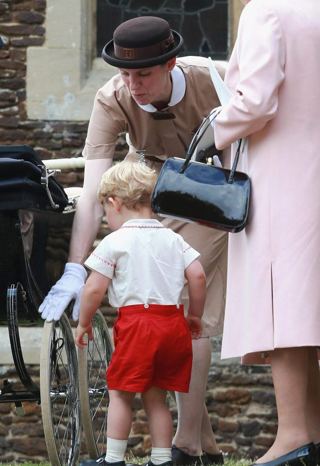  Nanny Maria keeps George away from the pram wheels during the christening of his sister Charlotte