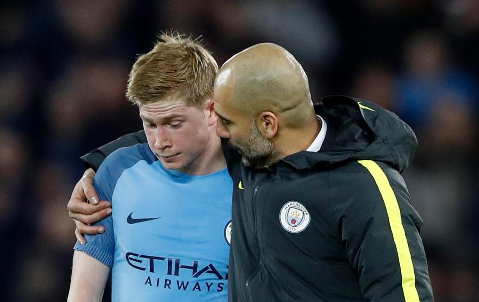  Guardiola puts an arm around De Bruyne at Anfield last season