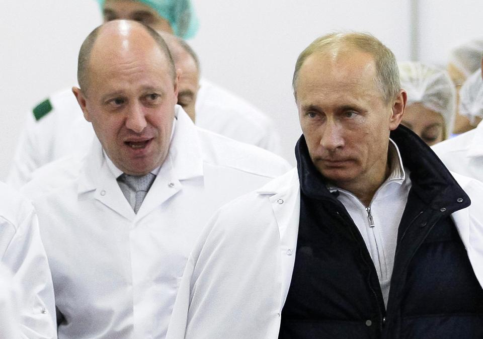  The troll farm was reportedly set up by Vladimir Putin's catering boss pal Yevgeny Prigozhin, left