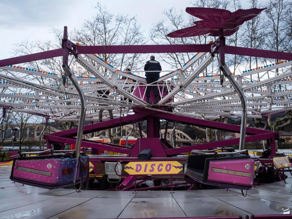  Policemen inspect a damaged fairground ride after an accident that killed one man on Saturday evening