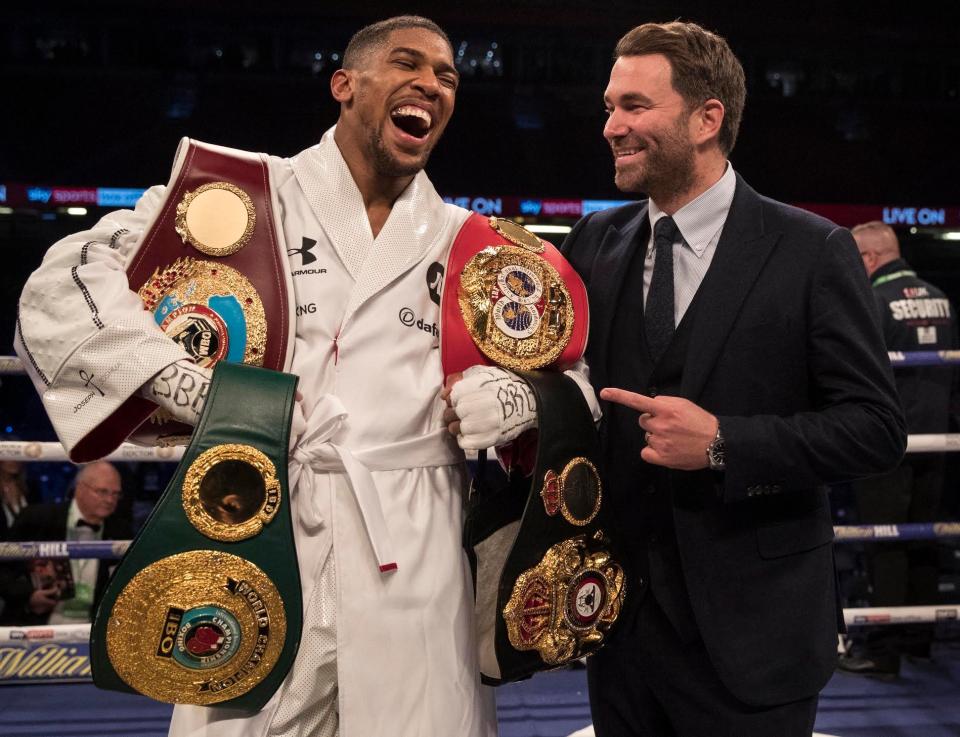  Anthony Joshua celebrates with promoter Eddie Hearn