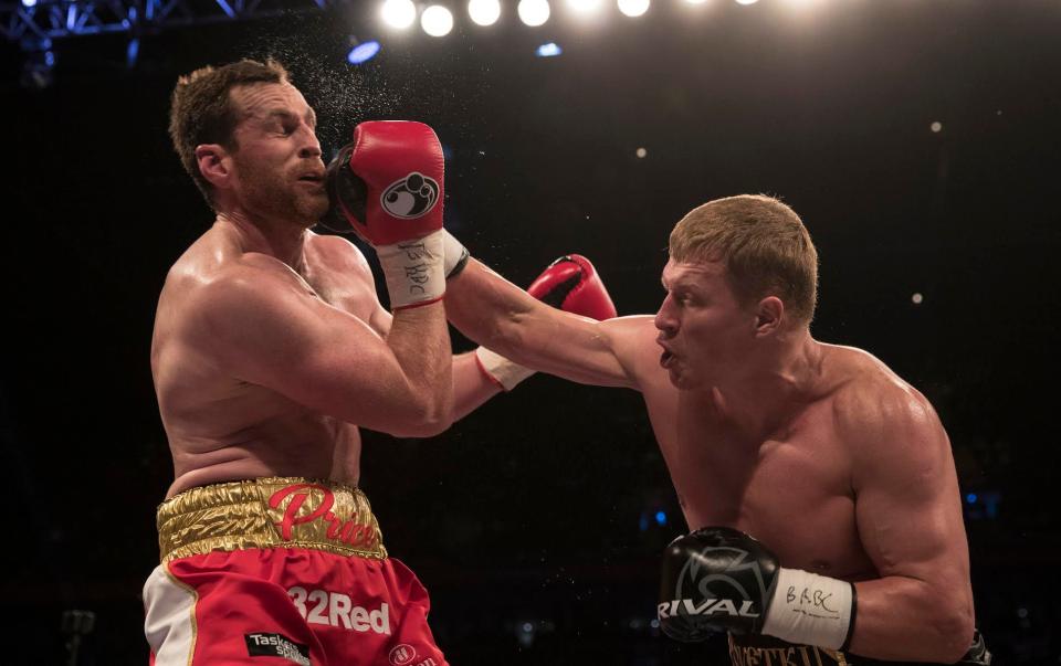  David Price is knocked back by a right hand from Alexander Povetkin