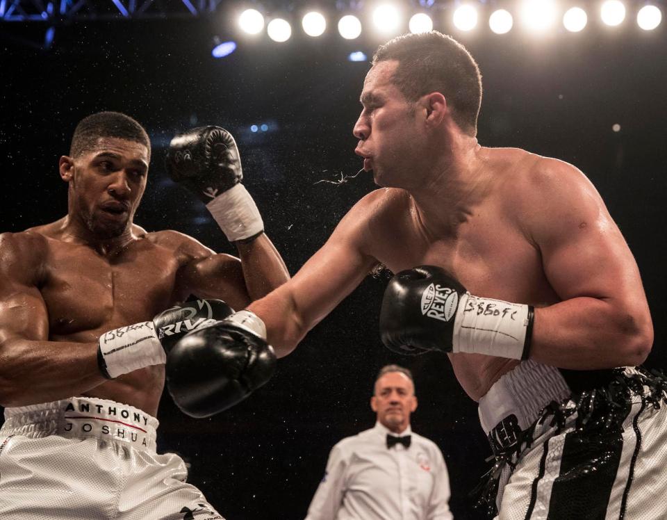  Anthony Joshua does well to dodge a right hook from his opponent