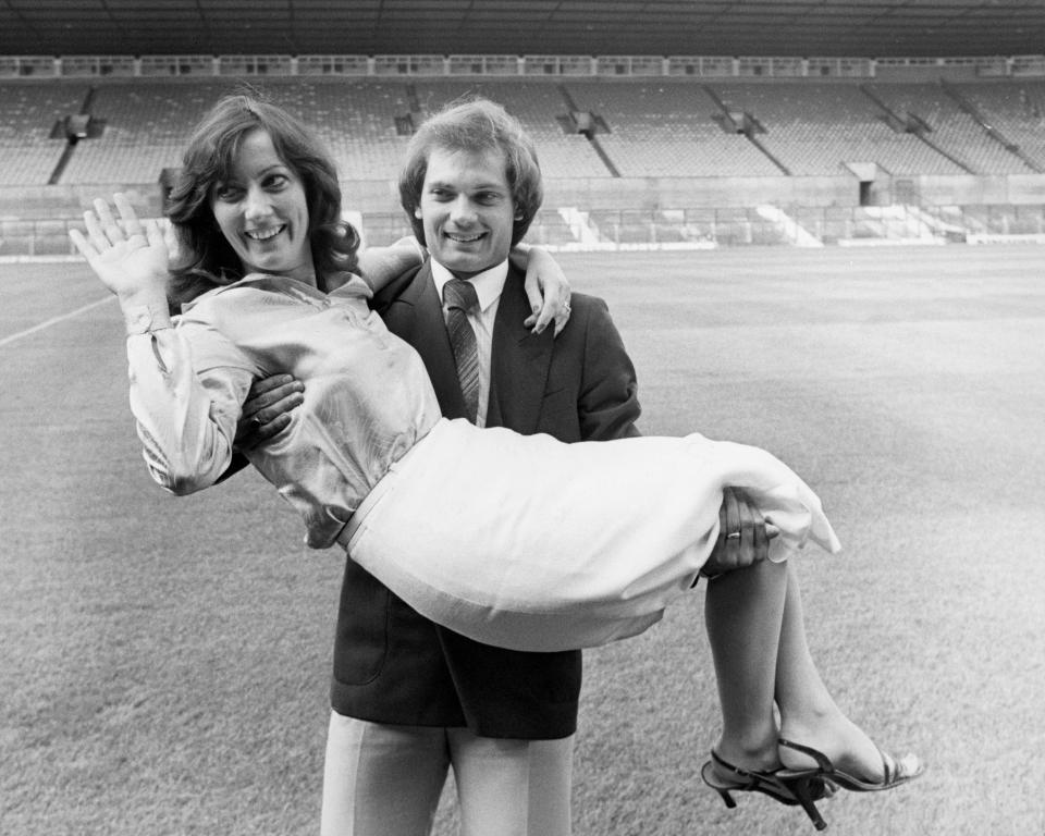  Wilkins lifts his wife, Jackie, aloft after signing for Manchester United