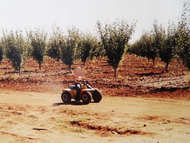 Pictured is a child riding a quad bike on the Australian family's farm of horrors