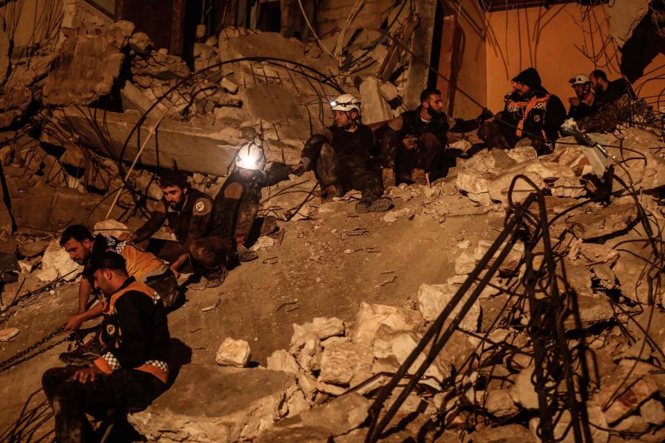  Syrian civil right defence members conduct a search and rescue operation on a destroyed building after an explosion,