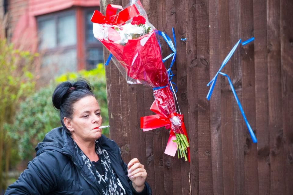  Vincent's aunt takes a break after re-tying bouquets to the fence - for the second time this afternoon