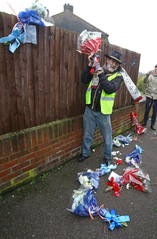  The bearded vigilante in a high-vis jacket was pictured ripping down the floral tributes outside Richard Osborn-Brooks house