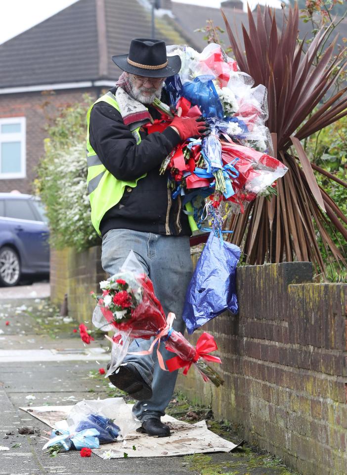  The stetson-wearing vigilante then picked up an armful of the flowers while kicking remaining bunches down the street away from the scene