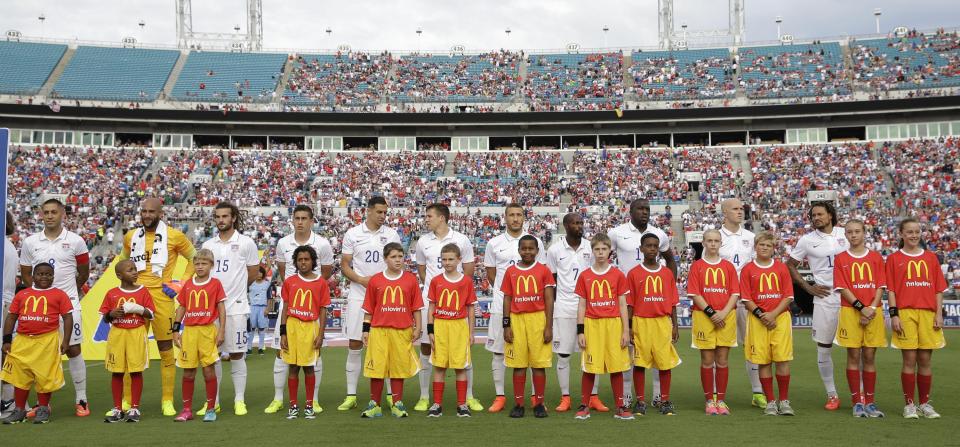  The United States team pictured with mascots wearing McDonald's shirts - this could be banned under new proposals