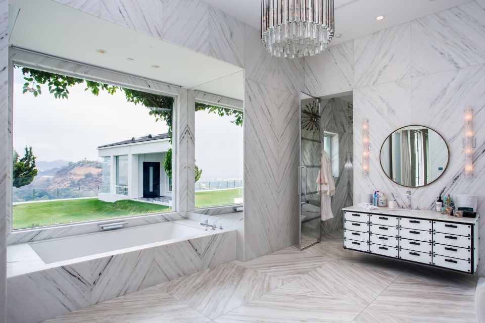 The home is decked in marble and chandeliers for a luxurious feel