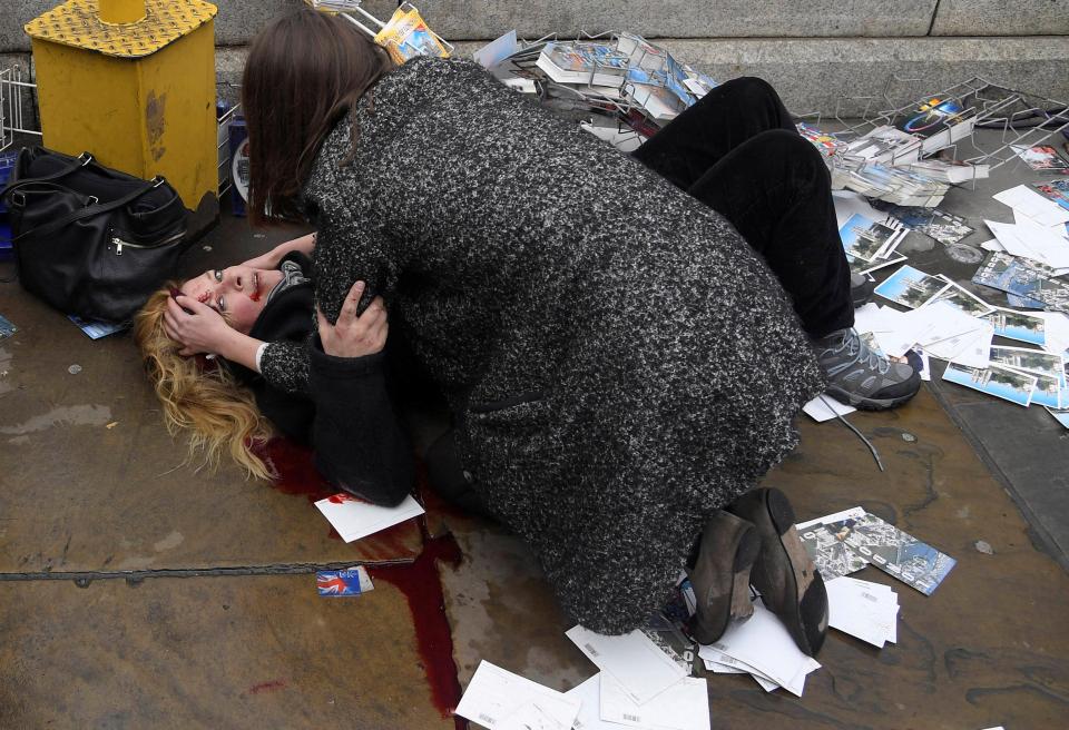  An American tourist being comforted by a passerby during London's Westminster terror attacks was the subject of a photo