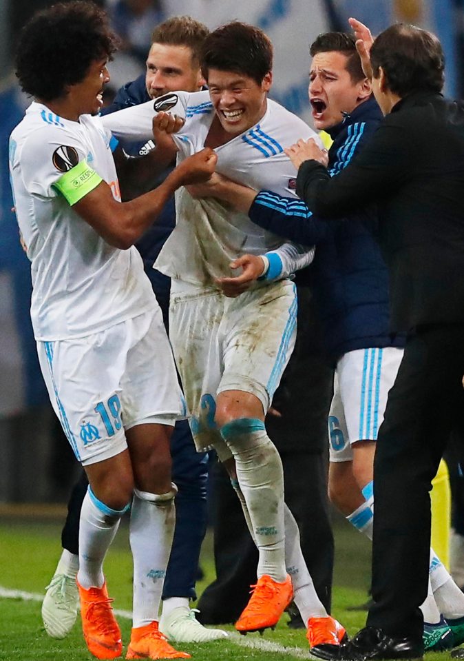  Hiroki Saka is mobbed after he rounds off a memorable night for Marseille