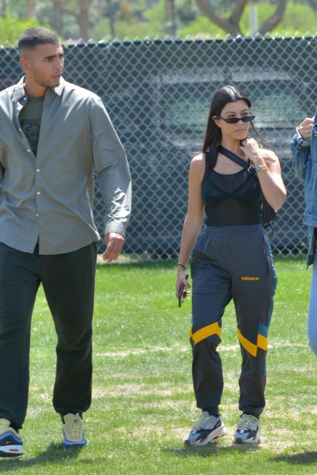  Kourtney looked festival ready in tracksuit bottoms and a black vest and she walked it with boyfriend Younes Bbendjima