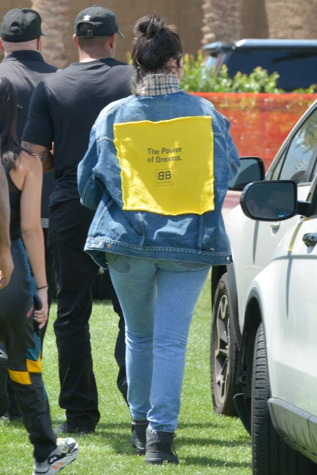  She arrived at the festival wearing a denim jacket and was sporting her natural brown hair