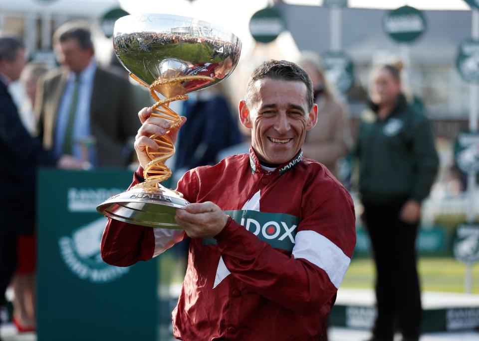  Davy Russell celebrates with the Grand National trophy