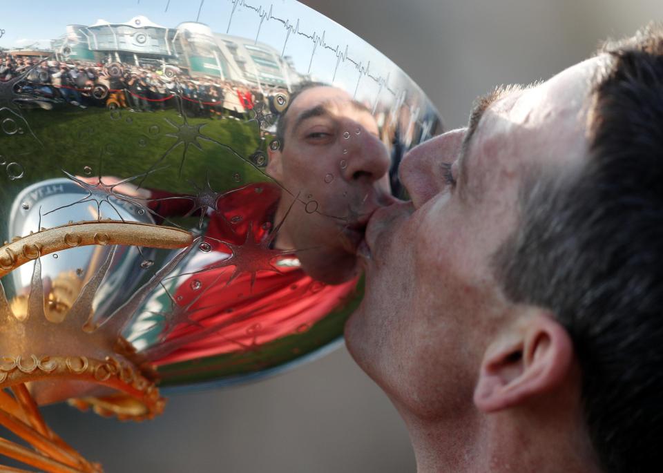  The 38-year-old jockey kisses the silverware after a stunning day where he won his first ever Grand National