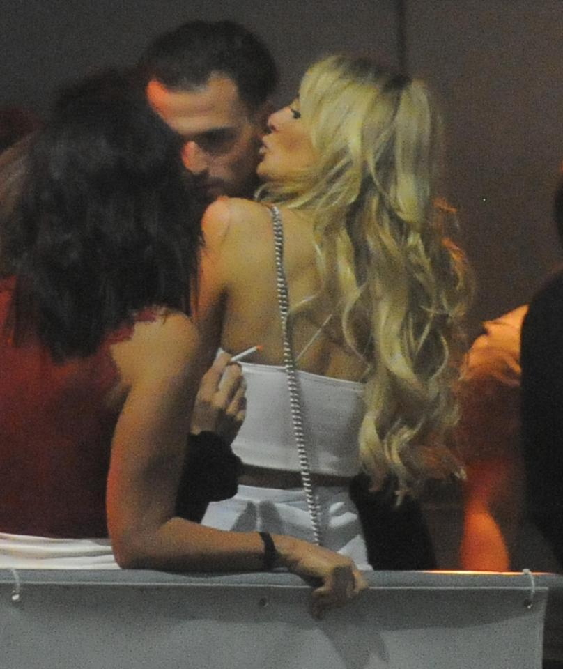  Olivia plants a kiss on Ronnie's face while in the club's smoking area