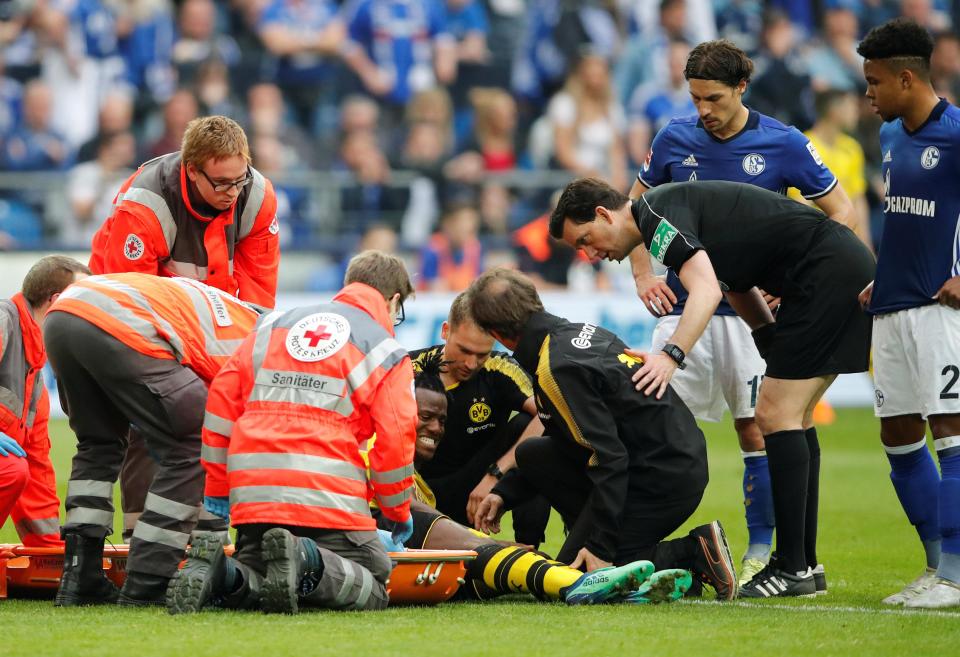  The Belgian striker winces in pain after he was tackled from behind by Benjamin Stambouli