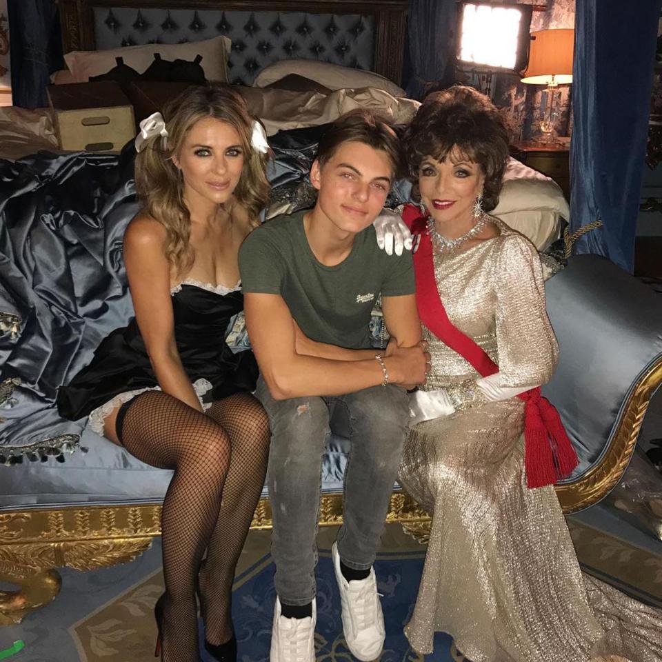  16-year-old Damian poses between his mum - clad in a french maids outfit - and Joan Collins. Posting the picture to Instagram, he wrote: "The Unholy Trinity"