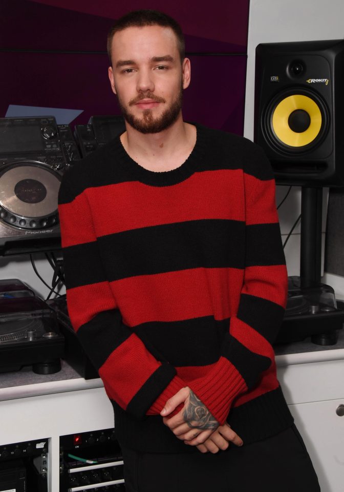  Liam Payne looks familiar in a red and black striped top