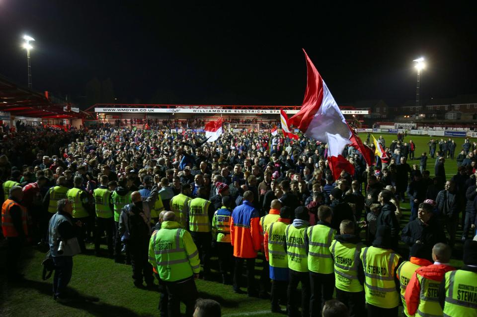  Accrington Stanley fans celebrate promotion after the final whistle