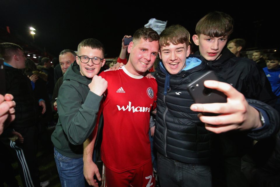  Billy Kee poses with delirious fans after sealing promotion to League One