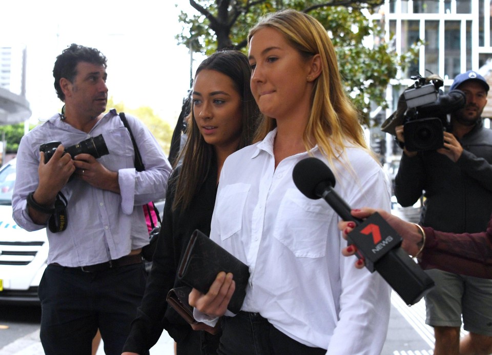 A woman, wearing a dark shirt, is believed to be a friend of Roberge and was seen leaving court in Australia