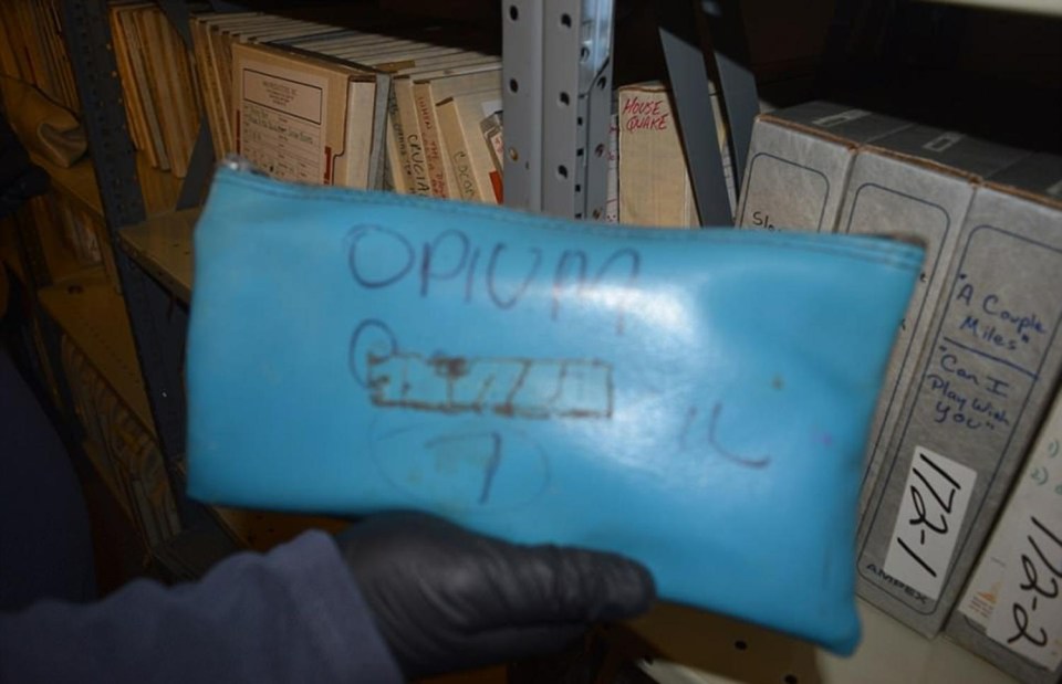 A blue pouch with the word 'opium' is found scrawled on the front