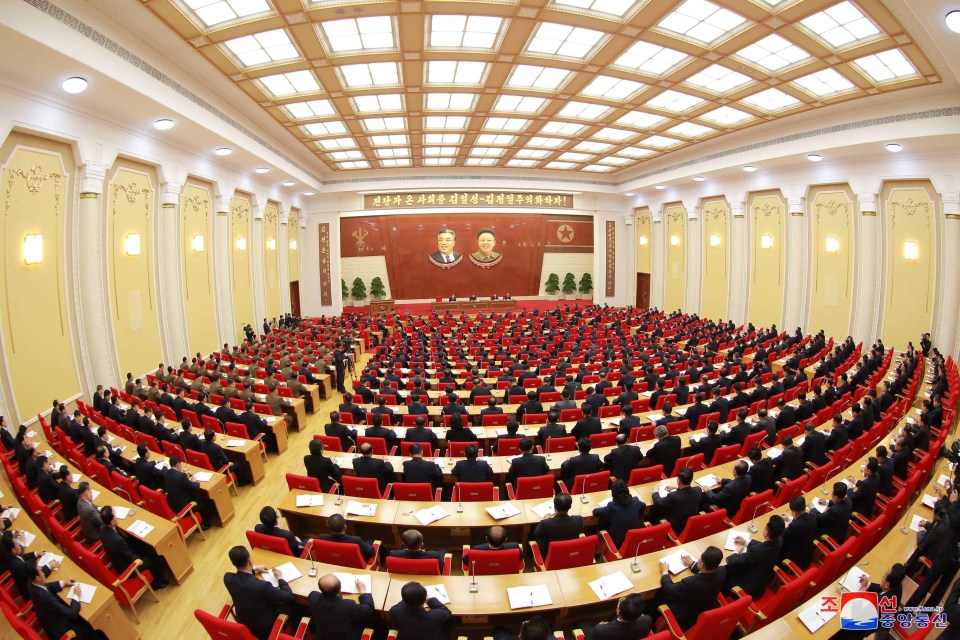 Attendees at the Third Plenary Meeting of the Seventh Central Committee of the Workers’ Party of Korea listen to Jong-un speaking