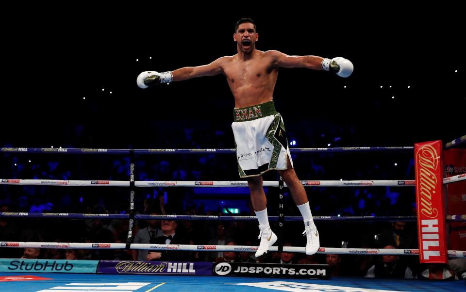  Amir Khan jumps for joy after his victory inside 40 seconds