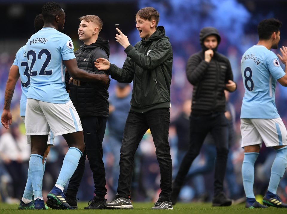  Fans invade the pitch and grab a moment with Benjamin Mendy and Jesus