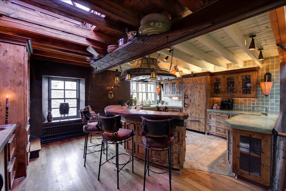  The kitchen and dining room open into a massive living room anchored by a large stone fireplace