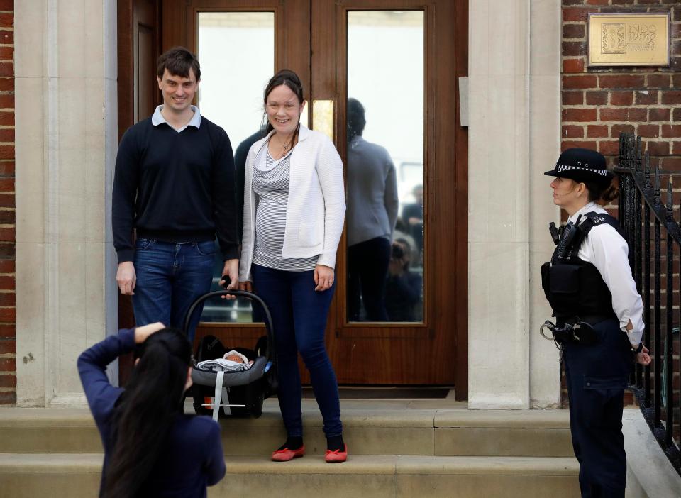  New parents pose for pictures today after leaving the Lindo Wing with their baby