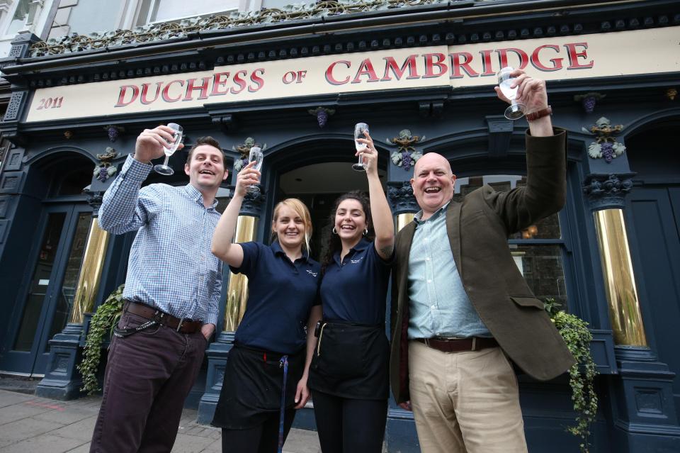  Customers and staff outside the Duchess of Cambridge pub in Windsor celebrate the news that the Duchess of Cambridge has given birth to a son