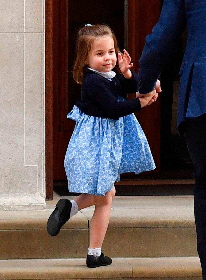  Princess Charlotte gives an adorable wave as she follows her dad and big brother into the hospital