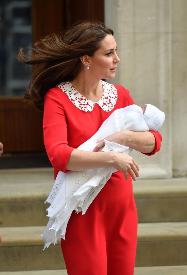 Kate Middleton in red and white Jenny Packham dress on steps of St. Mary's Hospital with new baby prince