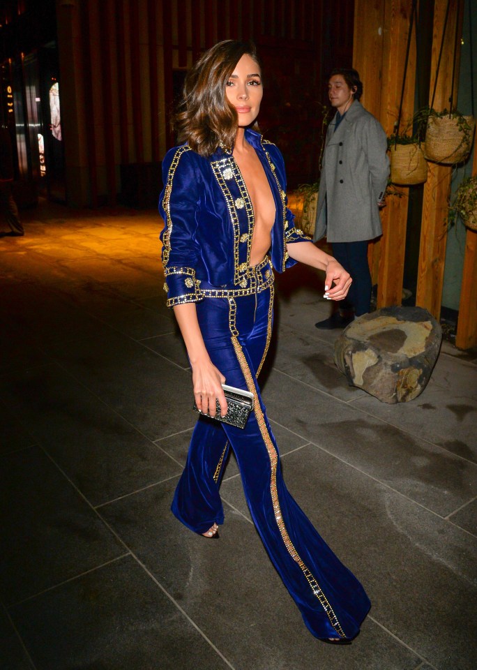 Olivia Culpo wore a blue and gold suit but decided to forgo a top