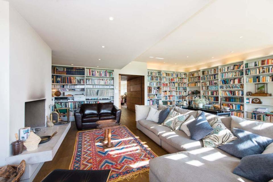  Bookshelves line the walls of the property's living room