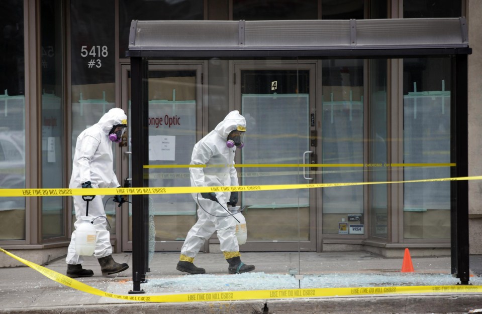 Hazmat workers work around the scene at Yonge St earlier today