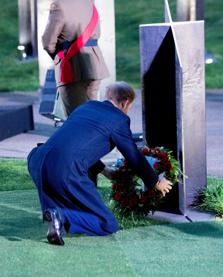 Prince Harry laid a floral wreath at one of a group of commemorative metal crosses